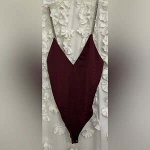 NWT XL burgundy body suit with rhinestone straps. Snaps underneath. Forever 21
